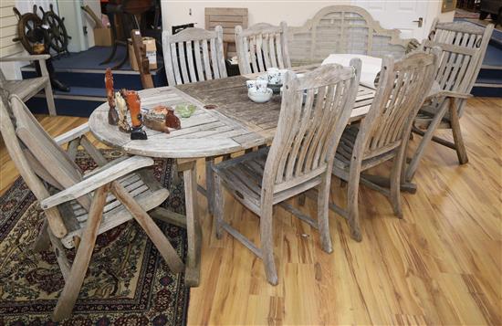 A teak garden table and six chairs Table W.124cm